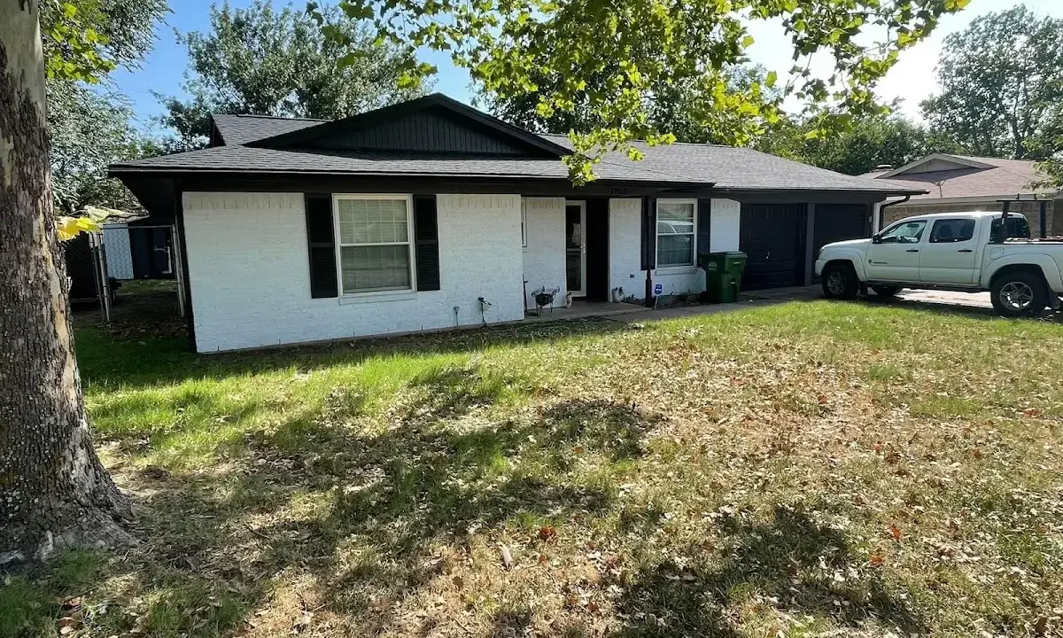 Professional roofing crew working on a residential roof in Plano